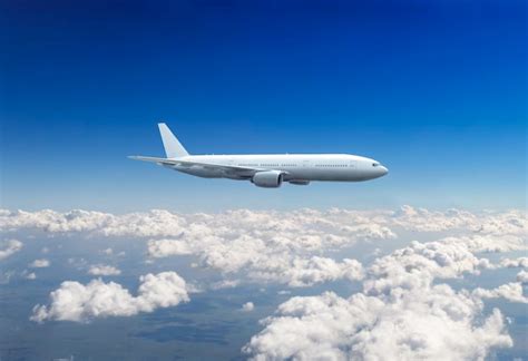 Premium Photo | Commercial passenger plane flying above clouds