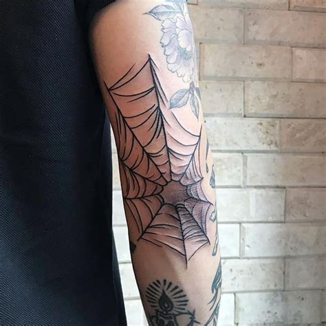Spider web tattoo on the right elbow - Tattoogrid.net | Web tattoo ...