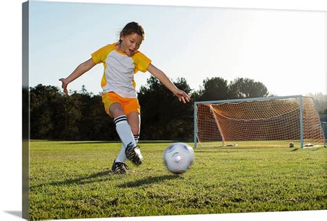 A young girl playing soccer on a soccer field in Los Angeles, California. Wall Art, Canvas ...