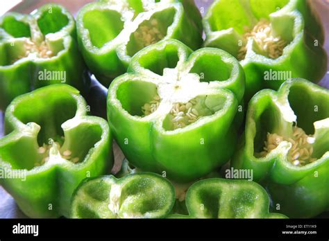 Spices ; half cut green chillies capsicum shimla mirch capsicum annuum ...