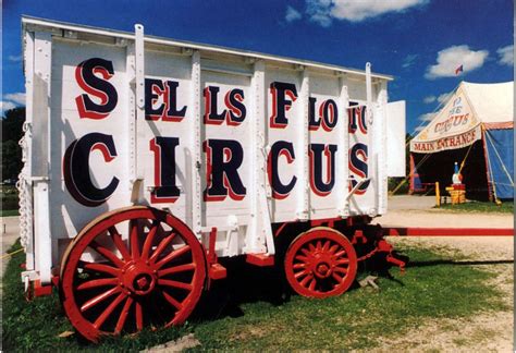 an old circus wagon is painted red and white with the word sells for circus written on it