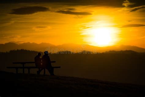 Couple Sitting on a Bench during a Sunset in the Mountains Stock Photo - Image of beautiful ...