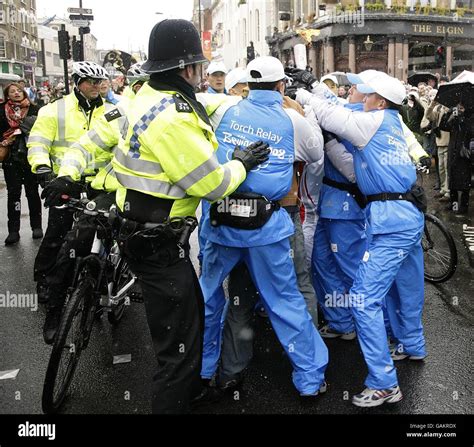 Beijing Olympics Torch Relay - London. Police tackle a demonstrator during Konnie Huq's leg of ...