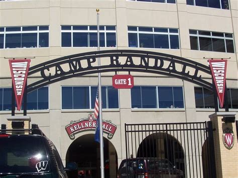 two cars parked in front of a building with flags on it's sides and the ...