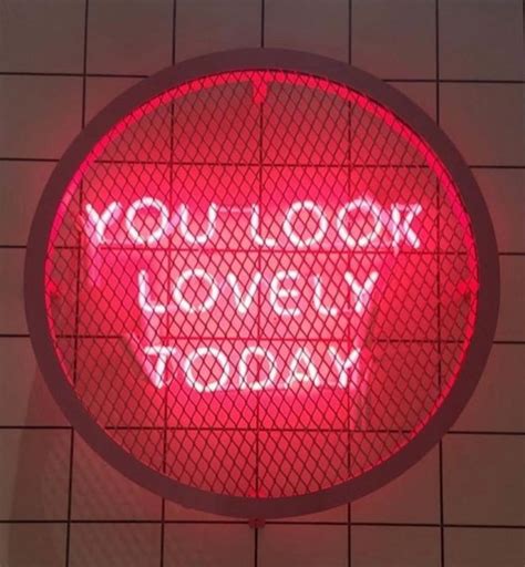 a red neon sign that says you look lovely today on the side of a wall