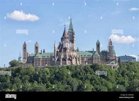 Parliament Buildings with flag flies half mast and Library, Ottawa ...