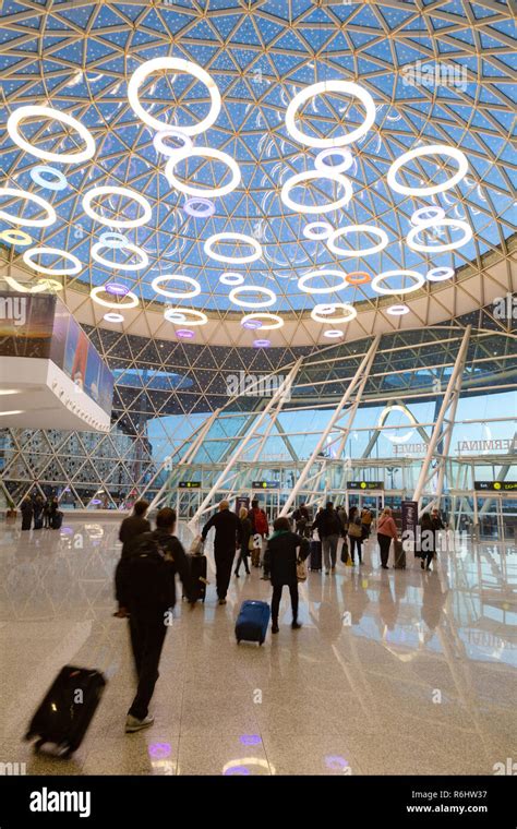 Marrakech airport - passengers in the interior of the modern arrivals terminal opened in 2016 ...