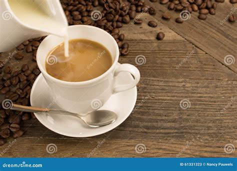 Pouring Milk in a Cup of Coffee. Stock Image - Image of milk, cream: 61331323