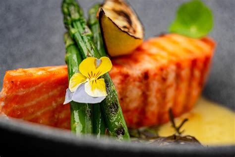 Premium Photo | Grilled salmon steak with cheese sauce and asparagus