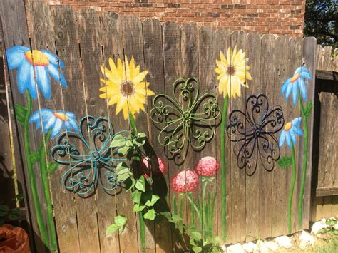 I painted flowers on the fence for my aunt today. The metal flowers and acrylic paint compliment ...