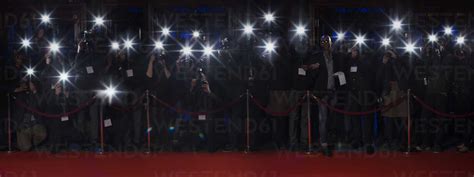 Paparazzi using flash photography along red carpet stock photo