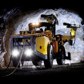 Two rock drills on a drill rig in their natural underground habitat ...