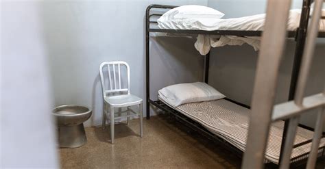 A Bunk Bed With Striped Foam Mattress in a Prison Cell · Free Stock Photo