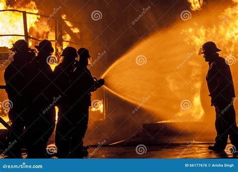 Firefighters Spraying Water To Put Out A Brutal Fire On The Truck ...