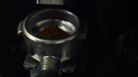 Process of grinding coffee beans in a coffee machine closeup 22108554 Stock Video at Vecteezy