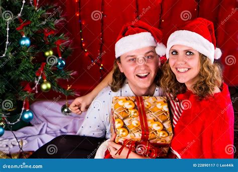 Young Happy Couple Near a Christmas Tree Stock Image - Image of holding ...