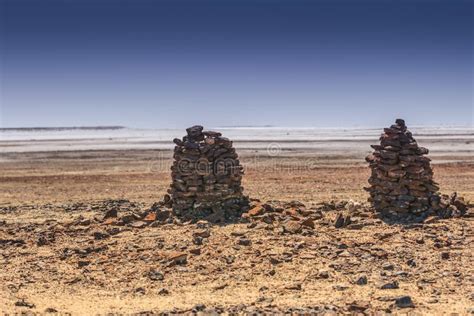 Two Stone Men Stand in the Heat on the Edge of Lake Eyre National Park ...