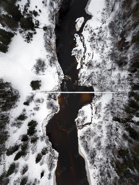 Winter forest. Bridge over river. In winter, snow, overcast. View from the drone Stock Photo ...