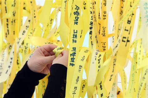 A visitor at the Sewol Ferry Memorial leaves a 'Nike' gift after ...