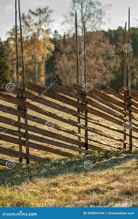 Traditional Northern European Roundpole Fence in a Grass Field during ...