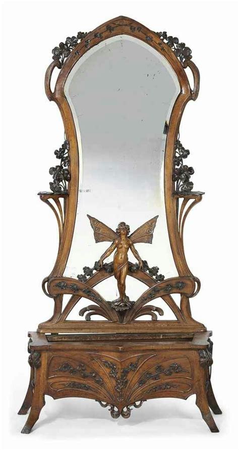 AN ART NOUVEAU CARVED WALNUT SCULPTURAL MIRROR AND JARDINIERE-STAND ...