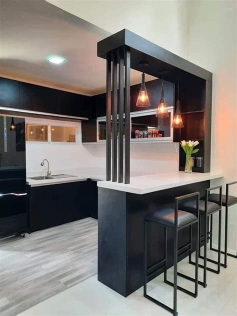 a kitchen with black cabinets and white counter tops