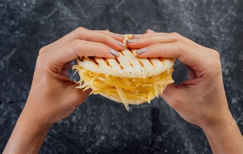 Premium Photo | Woman holding a cheese arepa, typical of venezuelan ...