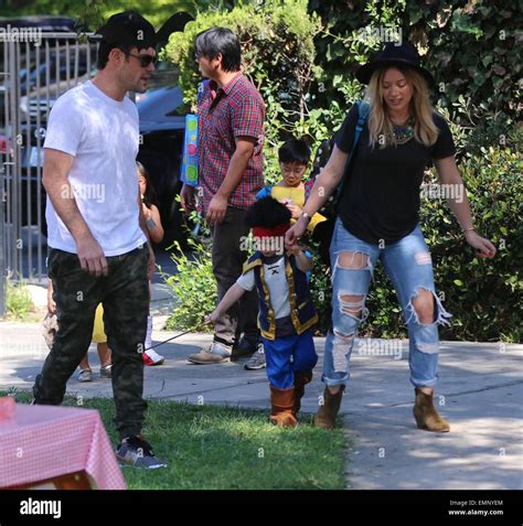 Hilary Duff, Mike Comrie, and their son Luca Comrie arrive at Luca's school for a Halloween ...