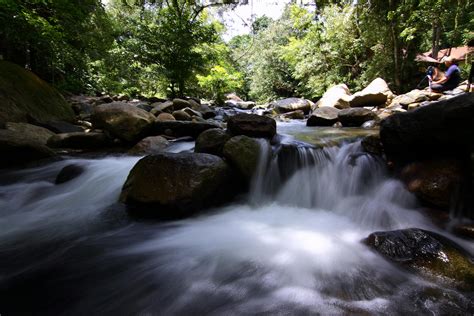 Man Sitting on Rock Near the Waterfalls · Free Stock Photo