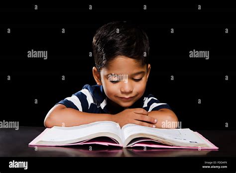 1 indian Kid Boy Student Reading Book Stock Photo - Alamy