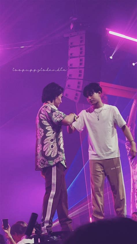 two people standing on a stage shaking hands