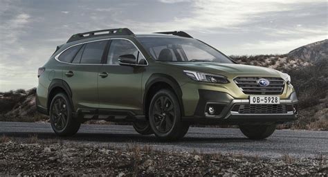 a green subarunt parked on the side of a road