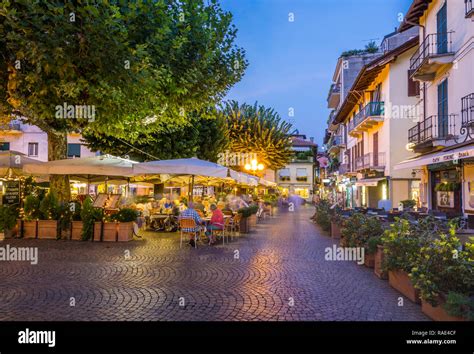 View of restaurants and souvenir shops in Stresa at dusk, Lago Maggiore, Piedmont, Italian Lakes ...