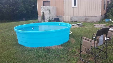 My hillbilly pool! 1,000 gallon blue poly stock tank. Got a pool pump at Walmart and drilled 2 h ...