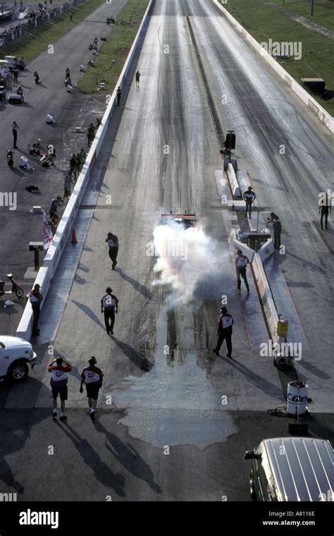 top fuel dragster burning out to heat the rear tires before a race Stock Photo - Alamy