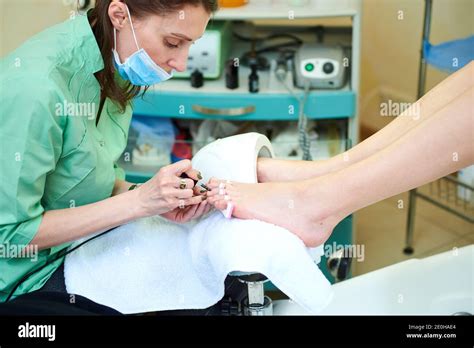 Woman getting a pedicure and relaxing at the beauty salon. Professional ...