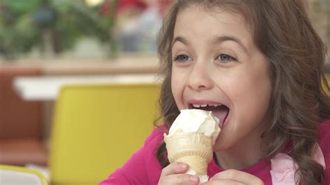 Happy and happy little girl eating ice cream at a cafe Stock Video ...