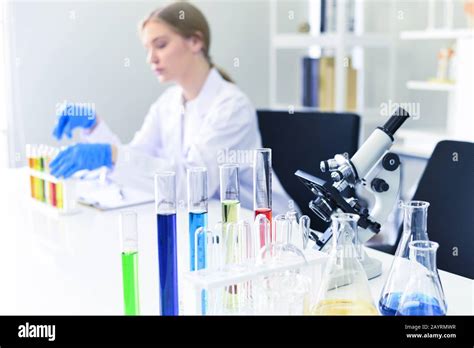 Young female scientist doing some research working conduct experiments ...