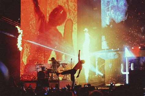 a person doing a handstand on stage in front of a crowd