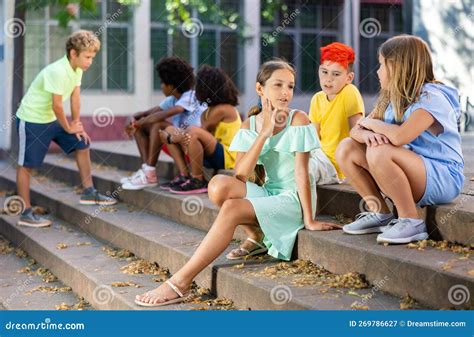 Positive Tweenagers Friendly Blabbing while Sitting on Steps Outdoors Stock Image - Image of ...