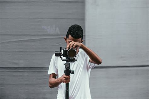 Man Holding Black Dslr Camera · Free Stock Photo