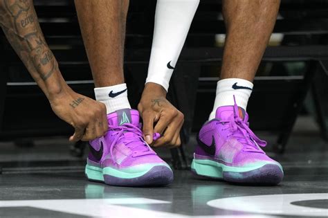 Memphis Grizzlies guard Ja Morant (12) ties his shoe before the game against the Golden State ...