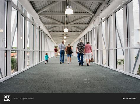 People walking in hotel walkway stock photo - OFFSET