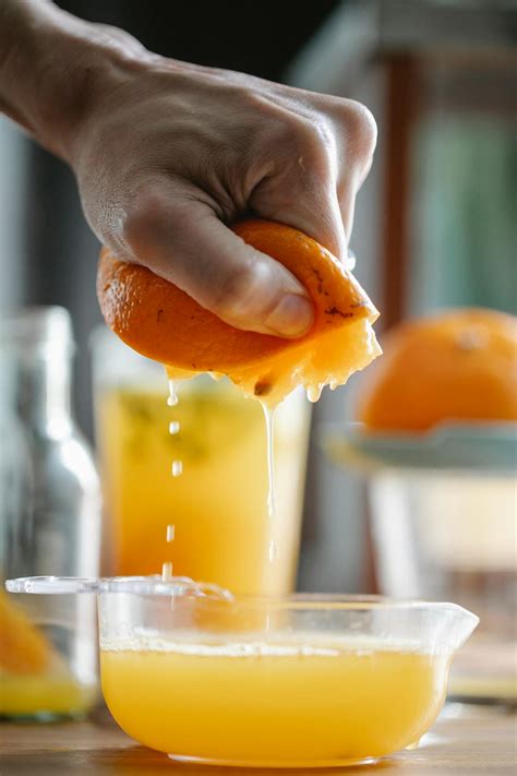 Crop person preparing fresh orange juice · Free Stock Photo