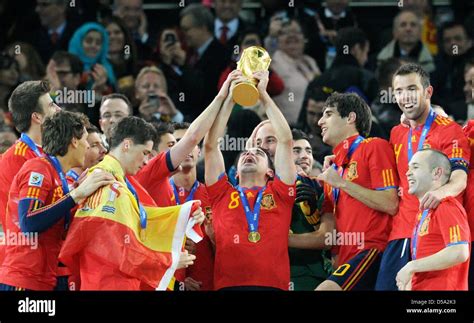 Xavi (C) of Spain lifts the trophy after the 2010 FIFA World Cup final ...