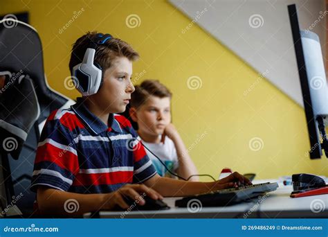 Two Kids Boys Playing Computer Games on Desktop Pc. Modern Addict ...