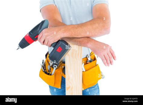 Midsection of male carpenter with power drill and plank Stock Photo - Alamy