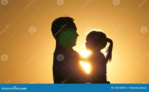 Daddy is Circling His Beloved Healthy Daughter in His Arms. Silhouette of Dad and Child at ...