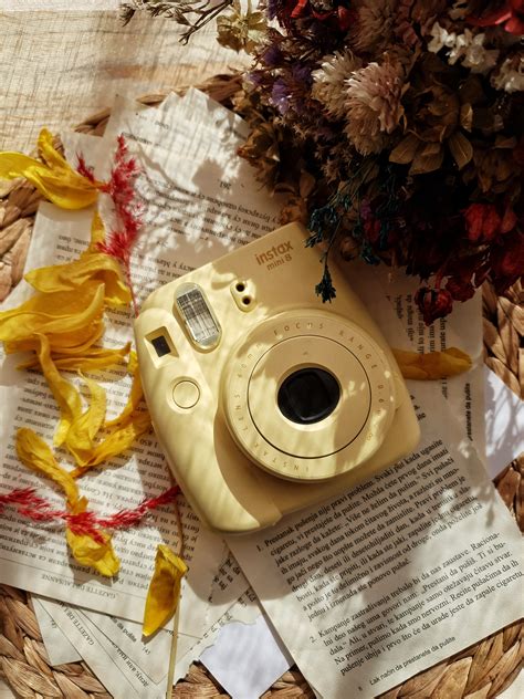 Yellow Instant Camera on Top of Ripped Paper Pages · Free Stock Photo