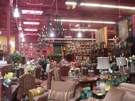 a large room filled with lots of furniture and flowers on the tables in front of them